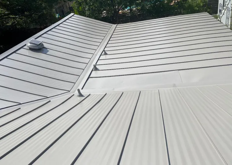 Solar attic fan installed on a metal roof for Roof Ventilation in Verdigris